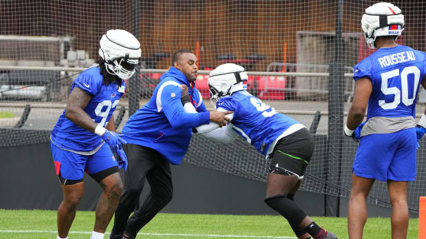 Jul 27, 2023; Rochester NY, USA; Buffalo Bills defensive end Shaq Lawson (90) blocks with assistant defensive line coach Marcus West during training camp at St. John Fisher College.